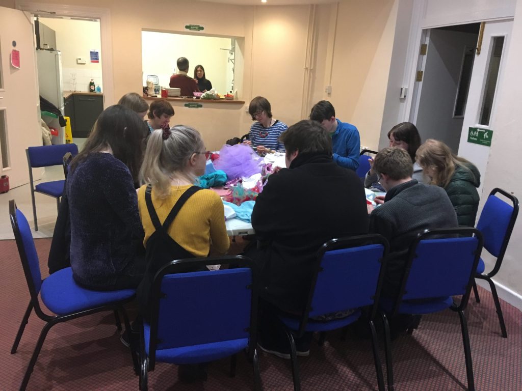 Group meeting taking place with young adults eating